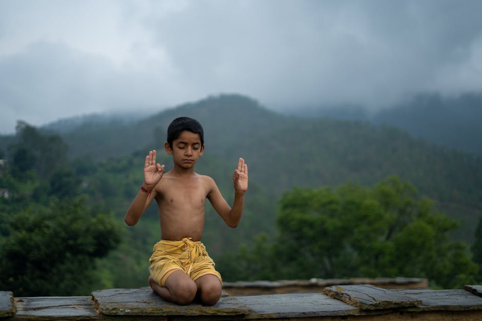 Person practicing yoga outdoors with a serene natural background